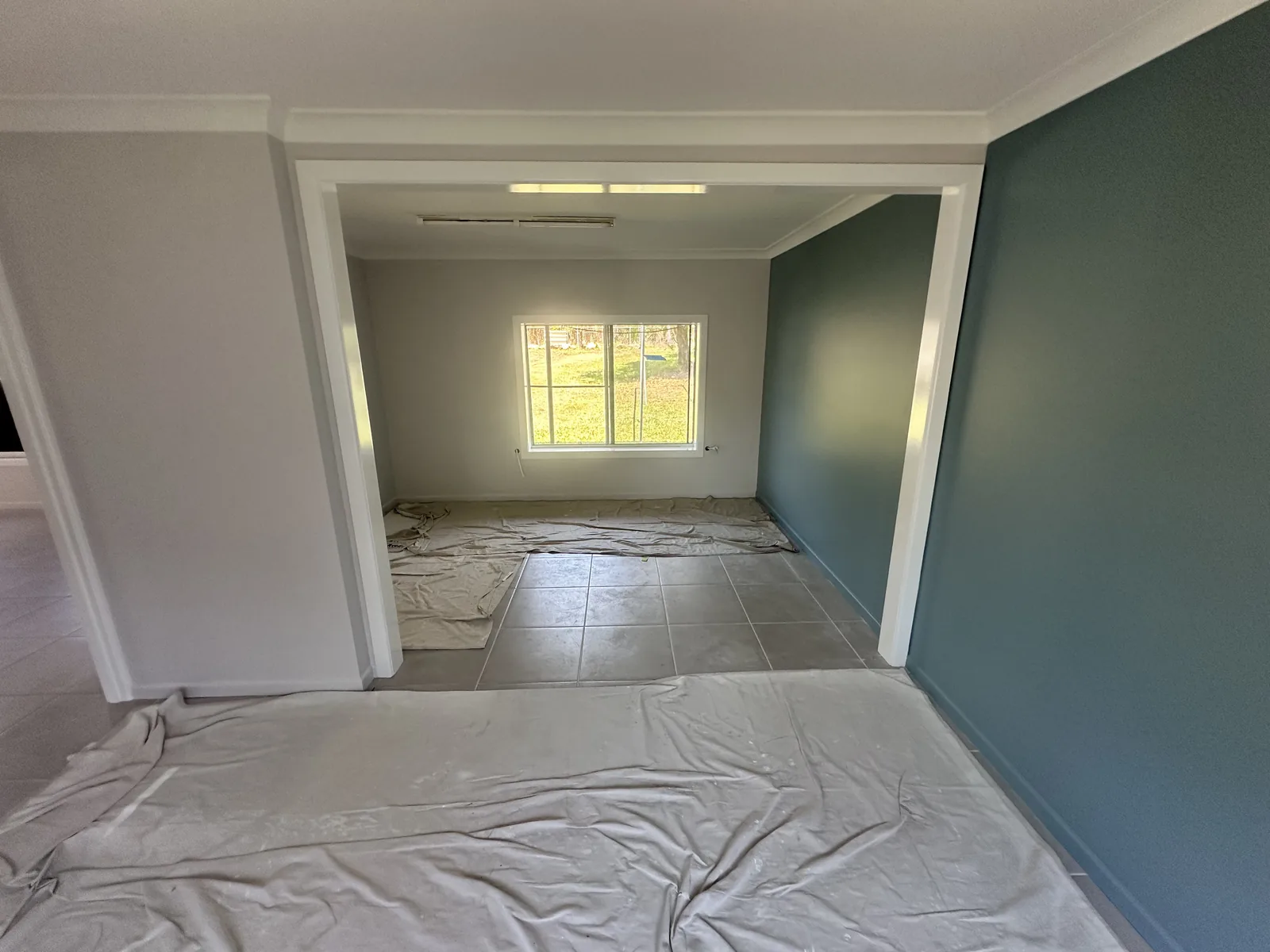 The same room painted, with a teal feature wall